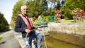 Eclusier qui pose devant l'écluse de la Maclais à Saint-Vincent-sur-Oust (56)